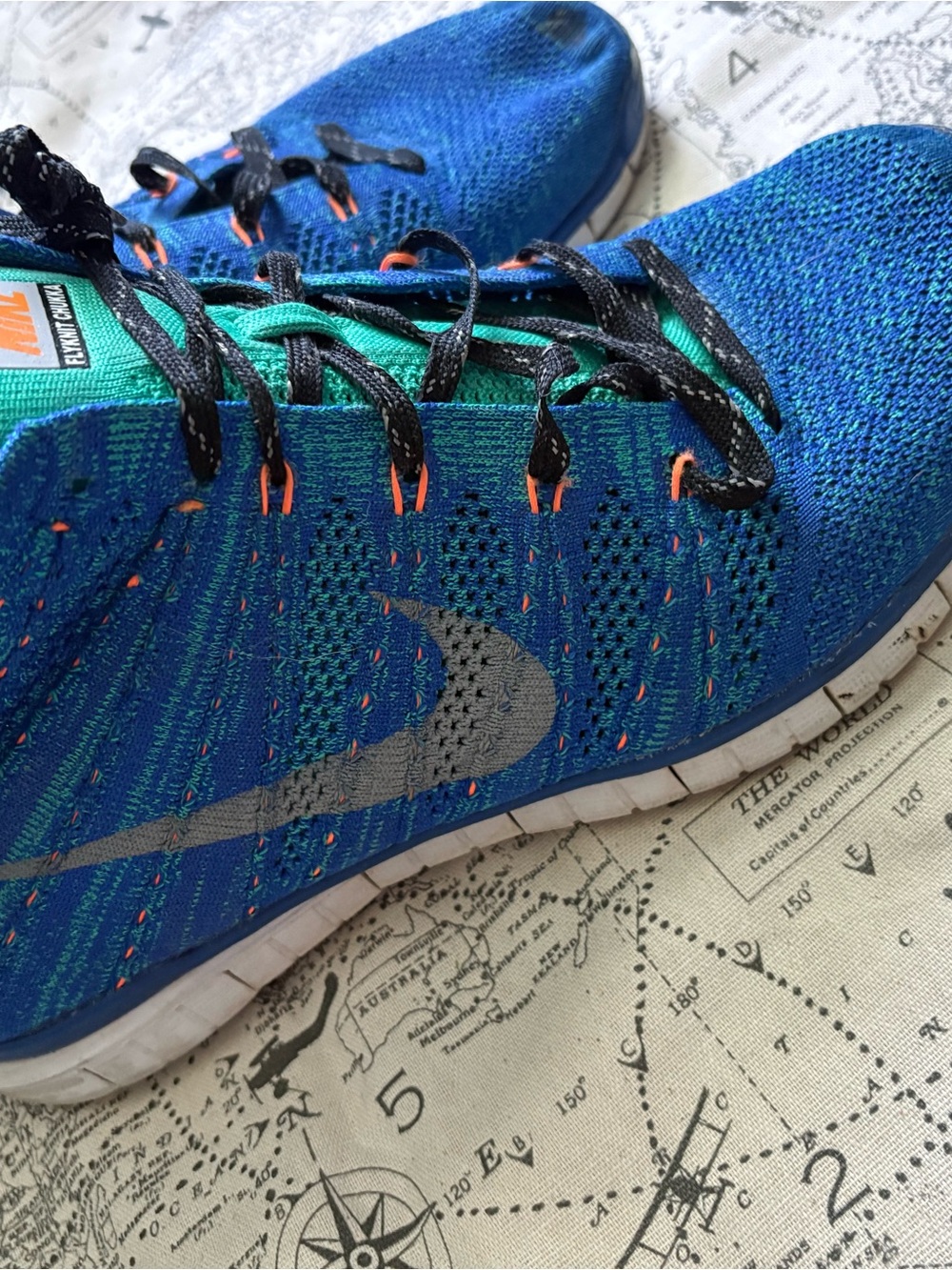 Nike Blue Flyknit Sneakers with Teal and Orange Details